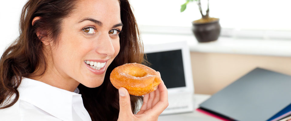Office worker eating doughnut